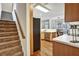 Staircase leading up adjacent to kitchen, showcasing appliances and breakfast nook at 5712 Overlook Cir, Powder Springs, GA 30127