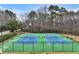 Two tennis courts with fences, benches and landscaping in a beautiful community setting at 5712 Overlook Cir, Powder Springs, GA 30127