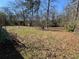 Expansive backyard featuring a blend of grassy areas and natural foliage, perfect for outdoor activities and relaxation at 614 Hunnicutt Se Rd, Mableton, GA 30126