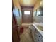 Bathroom featuring diamond pattern tiling and a single vanity at 614 Hunnicutt Se Rd, Mableton, GA 30126