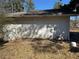 Side of home featuring white siding and glimpses of surrounding greenery at 614 Hunnicutt Se Rd, Mableton, GA 30126