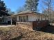 Side exterior view showing brick and siding details with natural landscaping at 614 Hunnicutt Se Rd, Mableton, GA 30126