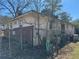 Rear corner of the house featuring siding, brick accents, and a fenced yard at 614 Hunnicutt Se Rd, Mableton, GA 30126