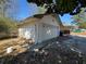 View of a detached garage with white siding and surrounding trees at 614 Hunnicutt Se Rd, Mableton, GA 30126