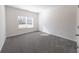 Bedroom featuring neutral carpet, a window, and closet at 7477 Caribou Trl, Riverdale, GA 30296