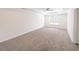 Spacious bedroom featuring neutral carpet, tray ceiling with fan, and a window for natural light at 7477 Caribou Trl, Riverdale, GA 30296