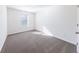 Cozy carpeted bedroom with a window providing natural light and freshly painted white walls at 7477 Caribou Trl, Riverdale, GA 30296