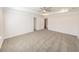 Large bedroom with neutral carpet, tray ceiling with fan, and ample space at 7477 Caribou Trl, Riverdale, GA 30296