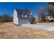 Well-maintained gray two-story home with a two-car garage and landscaped front yard at 7477 Caribou Trl, Riverdale, GA 30296