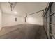 Spacious garage with a concrete floor, white walls, and an automatic door, perfect for parking and storage at 7477 Caribou Trl, Riverdale, GA 30296