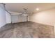 A garage with a bare concrete floor and white door, ready to park your car at 7477 Caribou Trl, Riverdale, GA 30296