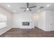 Bright living room with a modern fireplace, ceiling fan and dark wood floors at 7477 Caribou Trl, Riverdale, GA 30296