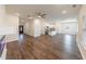 Open-concept living area with hardwood floors and a modern fireplace, flowing into the kitchen at 7477 Caribou Trl, Riverdale, GA 30296