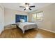 Bedroom with hardwood floors, a window with blinds, and blue decorative headboard at 1600 Briarcliff Ne Rd # 5, Atlanta, GA 30306