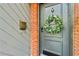Charming front door adorned with a wreath, set against a brick and gray exterior with a mailbox at 1600 Briarcliff Ne Rd # 5, Atlanta, GA 30306