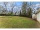 This spacious backyard is grass covered with a wood fence and some trees at 3169 Bluebird Ln, Decatur, GA 30032