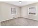 This bedroom features neutral walls, a ceiling light, carpet, and two windows to let in natural light at 3169 Bluebird Ln, Decatur, GA 30032