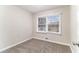 This bedroom features neutral walls, a carpet, and a window to let in natural light at 3169 Bluebird Ln, Decatur, GA 30032