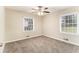 Inviting bedroom with neutral carpeting, a ceiling fan, and bright, natural light at 3169 Bluebird Ln, Decatur, GA 30032