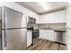 Modern kitchen featuring stainless steel appliances, granite countertops, and white cabinetry at 3169 Bluebird Ln, Decatur, GA 30032