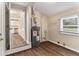 This laundry room has wood floors, a water heater, and a window to let in natural light at 3169 Bluebird Ln, Decatur, GA 30032