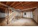 Unfinished basement framed with exposed wooden beams and stairs ready for customization at 4481 Buckingham Cir, Decatur, GA 30035