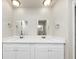 Bathroom with a dual sink vanity, ample lighting, and modern fixtures at 4481 Buckingham Cir, Decatur, GA 30035