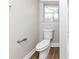 Cozy bathroom featuring a toilet with wood-look flooring and a window for natural lighting at 4481 Buckingham Cir, Decatur, GA 30035