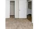 A carpeted bedroom featuring an open closet door and bathroom access at 4481 Buckingham Cir, Decatur, GA 30035