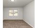 A bright bedroom with neutral walls, carpeted flooring and natural light at 4481 Buckingham Cir, Decatur, GA 30035