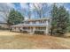 Charming two-story home with brick and siding, shutters, a covered front porch, and a well-manicured front yard at 4481 Buckingham Cir, Decatur, GA 30035