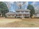 Charming two-story home with brick and siding, shutters, a covered front porch, and a well-manicured front yard at 4481 Buckingham Cir, Decatur, GA 30035