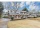 Charming two-story home with brick and siding, shutters, a covered front porch, a two car garage and a spacious front yard at 4481 Buckingham Cir, Decatur, GA 30035