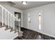 Inviting home foyer with slate flooring, staircase with white railing, and a front door with sidelight windows at 4481 Buckingham Cir, Decatur, GA 30035