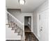Inviting home foyer with slate flooring, staircase with white railing, and a front door with sidelight windows at 4481 Buckingham Cir, Decatur, GA 30035