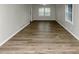 Bright living room featuring wood-look flooring, large windows, fresh paint, and modern trim at 4481 Buckingham Cir, Decatur, GA 30035