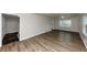 Bright living room featuring wood-look flooring, large windows, fresh paint, and modern trim at 4481 Buckingham Cir, Decatur, GA 30035