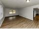 Bright living room featuring wood-look flooring, large windows, fresh paint, and modern trim at 4481 Buckingham Cir, Decatur, GA 30035