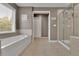 Bathroom with soaking tub, walk-in shower, and tile flooring at 104 Edgewater Trl, Canton, GA 30115