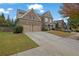 Charming brick home with a two-car garage and well-manicured lawn and driveway at 104 Edgewater Trl, Canton, GA 30115