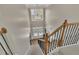 Bright foyer features a chandelier, stairs with wrought iron railings, and a view to the front door at 104 Edgewater Trl, Canton, GA 30115