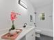 Stylish bathroom with quartz vanity, fresh flowers, and modern fixtures offering a luxurious experience at 937 Camilla Sw St, Atlanta, GA 30314