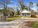 White cottage-style house with a wooden fence, driveway and a well-manicured front lawn at 937 Camilla Sw St, Atlanta, GA 30314