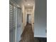 Bright hallway with wood-look floors and white doors at 937 Camilla Sw St, Atlanta, GA 30314