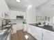 Modern kitchen with white cabinets, granite counters, stainless steel appliances, and breakfast bar at 937 Camilla Sw St, Atlanta, GA 30314