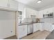 Bright kitchen features white cabinets, stainless steel appliances, and black granite countertops at 937 Camilla Sw St, Atlanta, GA 30314