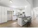 Modern kitchen with white cabinets, sleek countertops, and a breakfast bar with seating at 937 Camilla Sw St, Atlanta, GA 30314