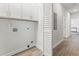 Clean laundry room with white cabinets and shelving for convenient storage at 937 Camilla Sw St, Atlanta, GA 30314