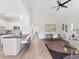 Open-concept living space with kitchen, dining, and living area featuring vaulted ceilings at 937 Camilla Sw St, Atlanta, GA 30314