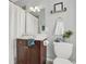 Bathroom has a single sink vanity with wood cabinets and a shower with white curtain at 1583 Mosaic Way, Smyrna, GA 30080
